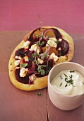 Beetroot and potato pizza with sheep's cheese and herb quark