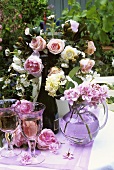 White wine and summer flowers on a garden table