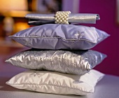 Stack of cushions and napkin with ring