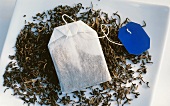 Tea bag on dried tea leaves