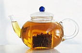 Glass teapot full of tea