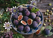 Bowl of figs, hazelnuts, flowers