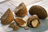 Three unshelled and two shelled Brazil nuts on wooden background