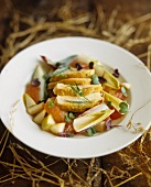 Chicken breast on fruit salad with chicory