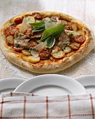 Pizza topped with pork fillet and potatoes