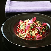 Couscous with pomegranate seeds and rose petals