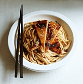 Squid with sesame seeds on noodles
