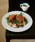 Beef fillet on a spinach salad with mushrooms