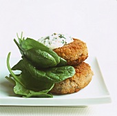Fish cakes with sauce tartare and baby spinach
