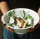 Spinach salad with avocado and grilled chicken breast