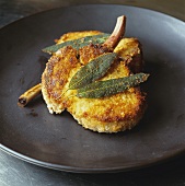 Pork chops covered in breadcrumbs with mustard and sage