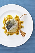 Bass with white bean puree and bacon chips