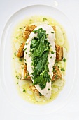 Chicken breast with wild herb spinach on a bed of fried mushrooms
