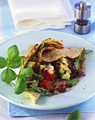 Pancake filled with tomato and avocado salad