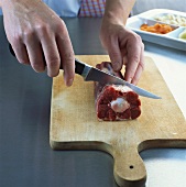 Separating the joints of an oxtail with a knife