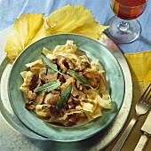 Sliced venison with mushrooms and sage on ribbon pasta