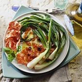 Marinated spring onions with tomato salad and ham