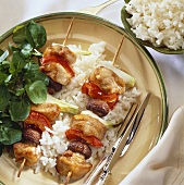 Chicken and vegetable kebabs on rice