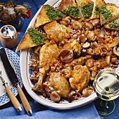 Braised chicken with vegetables, bacon and mushrooms
