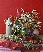 Still life with olives, olive branches, tomatoes & peppers