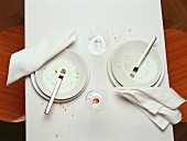 Empty plates and wine glasses (after a meal)
