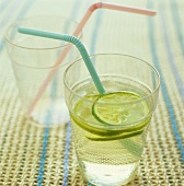 Limeade in a glass with a straw