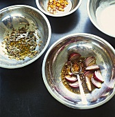 Four different spicy marinades in metal bowls
