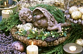 A little angel lying in a winter arrangement