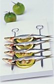 Four stuffed sardines on two skewers