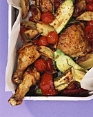Oven-baked chicken legs, potatoes and vegetables