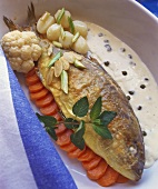Sea bass with almond and caper sauce and vegetables