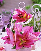 Lilies on tiered stand with ribbons