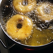 Frying pineapple fritters in fat