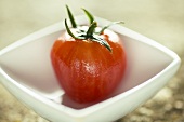A peeled tomato in a small dish