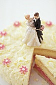 A wedding cake with a piece cut