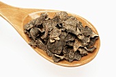 White truffle shavings on wooden spoon