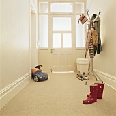 A toy and a clothes stand in an entrance hall