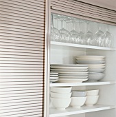 Plates and glasses in a kitchen cupboard