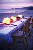 Set table on beach at twilight