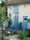 Cats and garden furniture on terrace