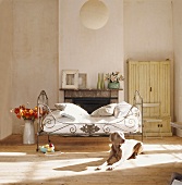 Dog lying on floor in front of bed