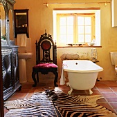 Zebra-skin rug in front of free-standing bathtub
