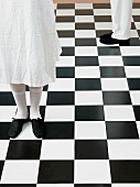 Feet on chequered floor