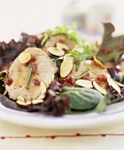 Rolled pork roast with almonds on salad