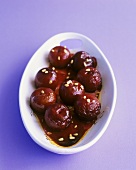 Plums in syrup with pine nuts