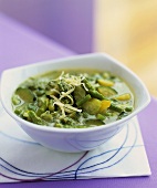 Spring vegetable soup with cheese and pesto