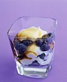 Yoghurt with honey and blueberries in a glass