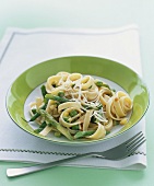 Ribbon pasta with green asparagus, courgettes and peas