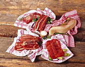 Various cuts of meat on tea towels