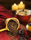 Pu-erh tea in tea bowl, loose tea leaves and pressed tea